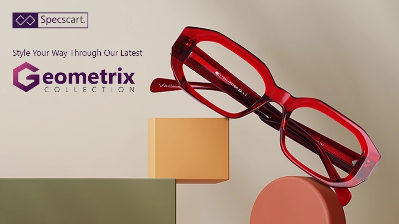 A pair of bold, red, geometric-shaped eyeglasses is displayed on a composition of colourful, geometric blocks. The background is a soft, neutral tone.