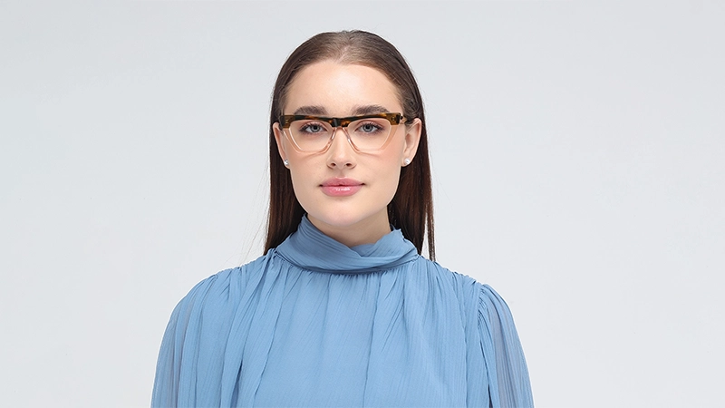 Woman wearing two-tone cat-eye glasses with a tortoiseshell brow and clear bottom.