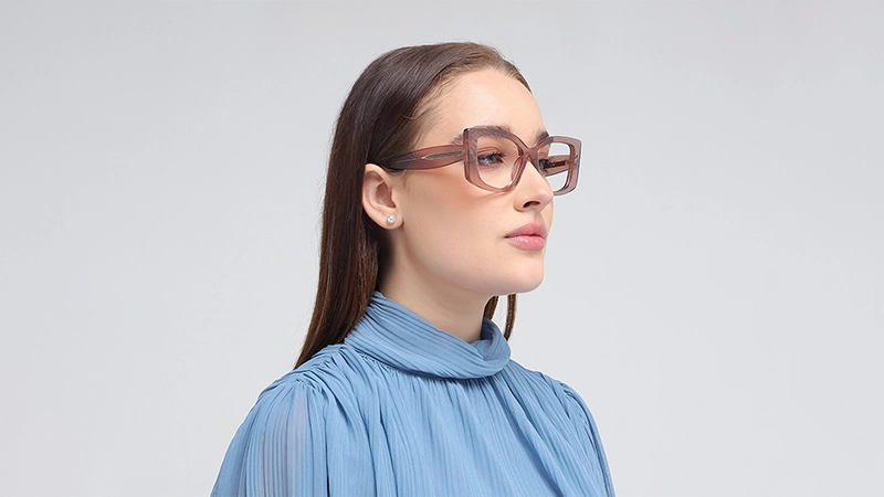 Woman in profile wearing oversized translucent mauve rectangular glasses.