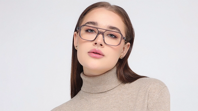 Woman in beige turtleneck wearing translucent grey double-bridge pilot glasses.