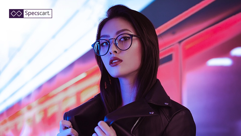 An Asian model wearing round black frames designed with a low bridge fit for comfort and a secure, non-slip grip.