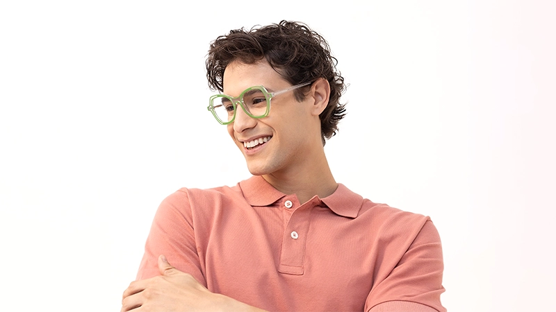 Smiling man wearing lime green geometric glasses, symbolizing freshness and a balanced personality through color choice.