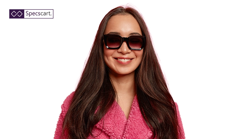 A smiling woman wearing thick black square sunglasses with gradient lenses, showcasing stylish gradient tinted eyewear.