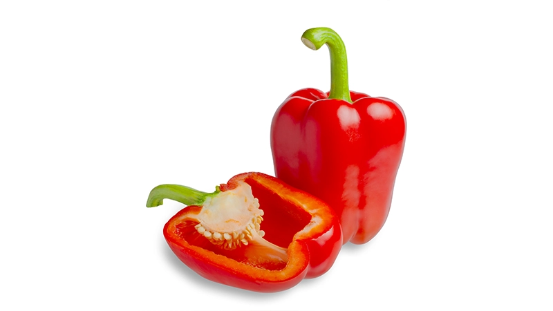 Red bell pepper shown whole and halved, highlighting vitamin-rich foods that support healthy eyes.