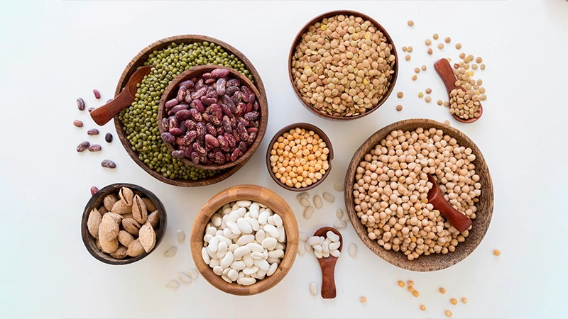Assorted beans, lentils, and chickpeas in bowls, highlighting zinc-rich foods that support healthy eyes.