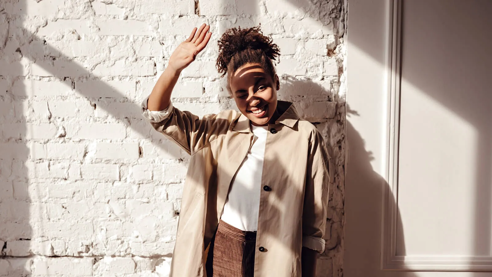 What are the Effects of High Energy Visible Light on the human body? A woman shielding her eyes from bright sunlight, highlighting the sun as the most significant natural source of high-energy visible light.