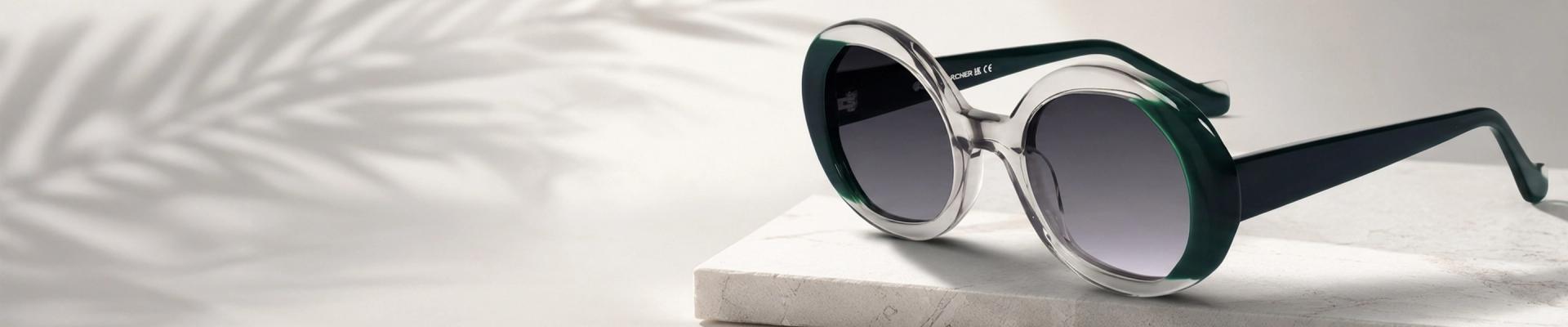 Oversized Sunglasses Model wearing oversized dark sunglasses and a black blazer, looking to the side. The image highlights a bold, fashionable eyewear style.
