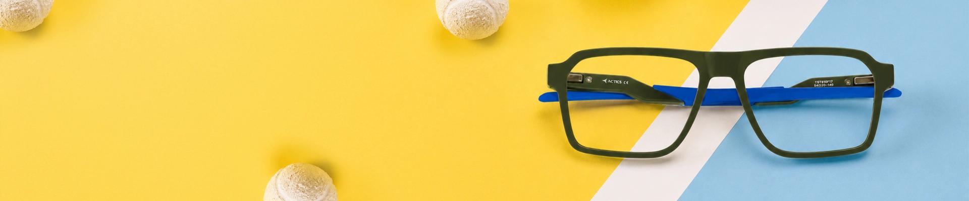 TR90 Glasses Image showing a lightweight pair of black rectangular TR90 glasses with vibrant orange inner arms, positioned diagonally on a soft pink glasses case, promoting TR90 sports glasses range.