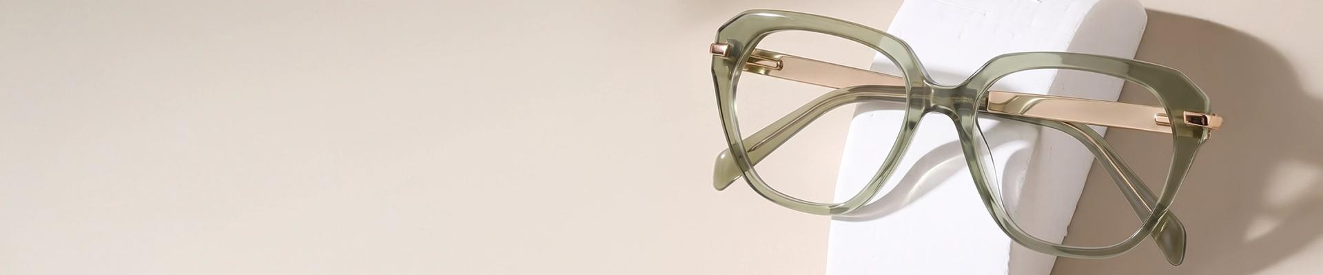 Green Glasses The image features a pair of green eyeglasses with black and tortoiseshell temples. It has a rectangular shape and is placed over a white stand against a light green background. It also has text saying Green Glasses, discount offer and Trustpilot Reviews.