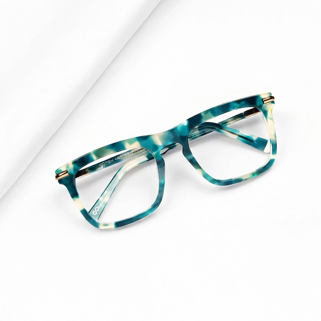 Keyhole Glasses Stylish black keyhole bridge glasses with subtle blue temple tips placed on a marble block, highlighting Specscart’s modern eyewear design.