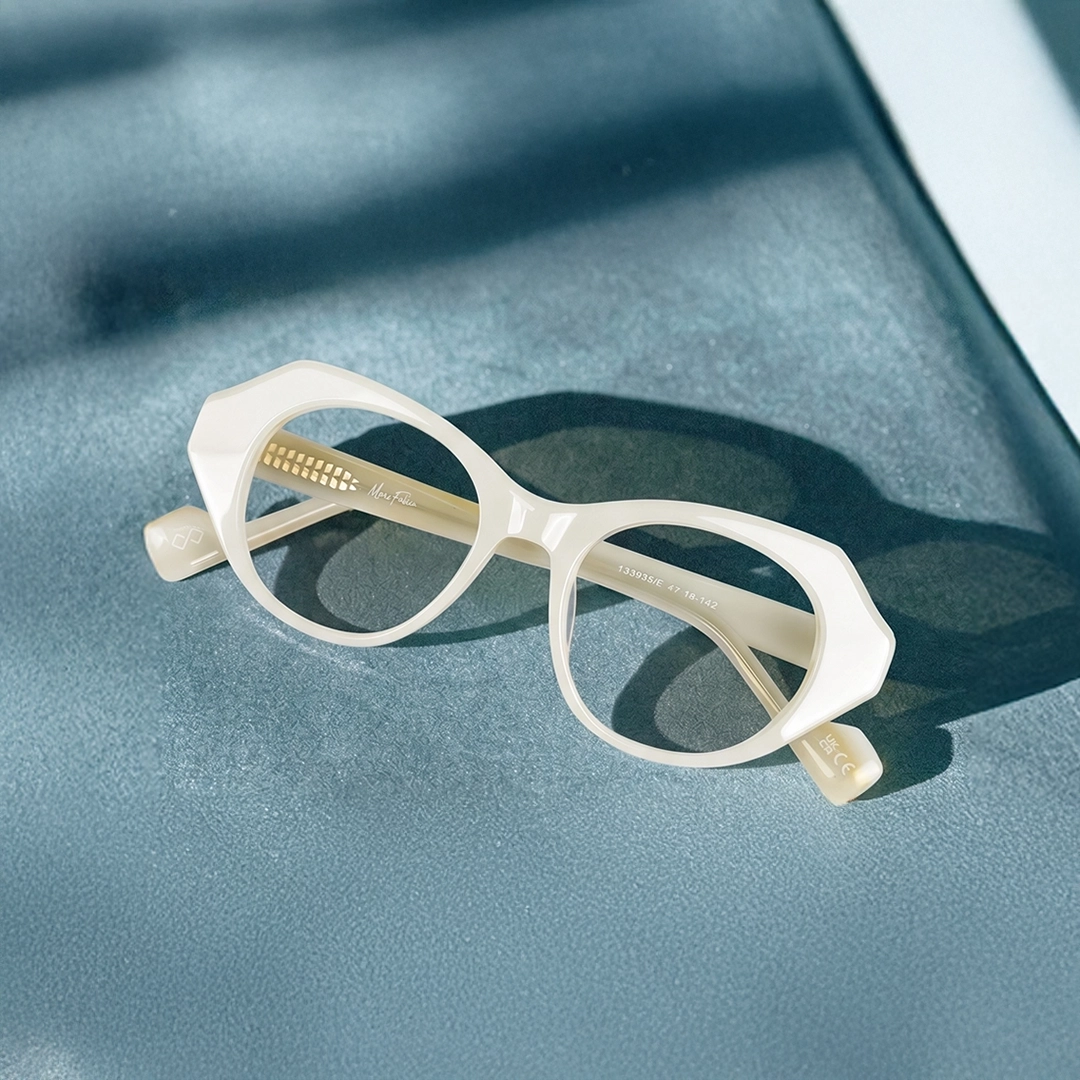 White Glasses Chunky white geometric glasses with a pink and black striped browline on a cream background.