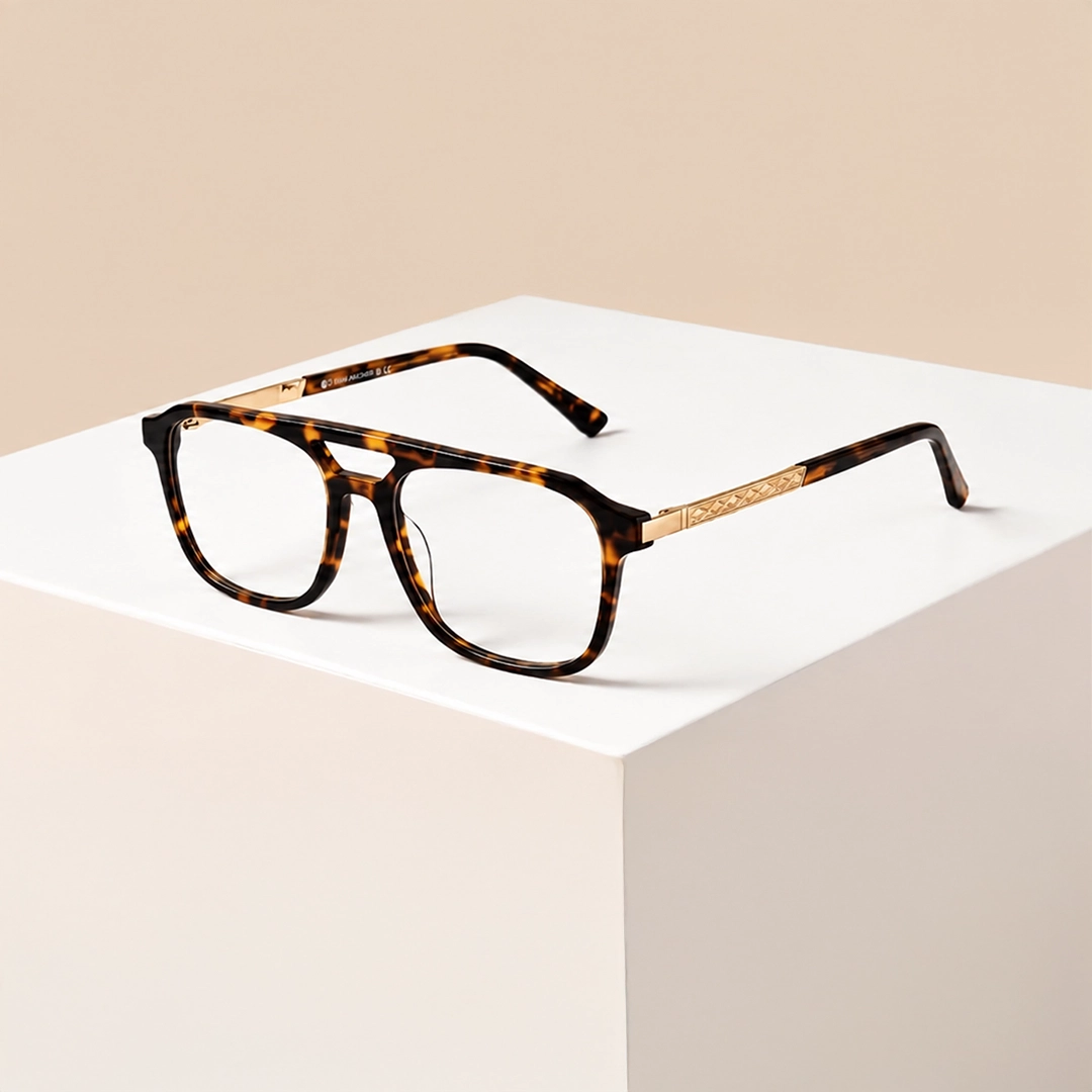 Leopard print round eyeglasses with yellow gradient tips displayed on a white cylindrical stand against a soft gradient background