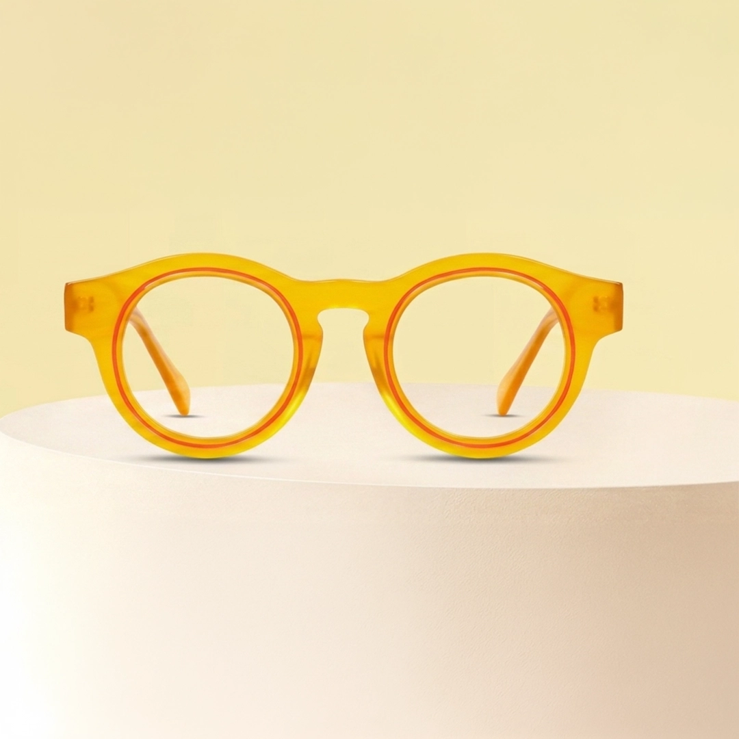 Round Glasses Thick-rimmed round tortoiseshell glasses with translucent green temples on a neutral beige background.
