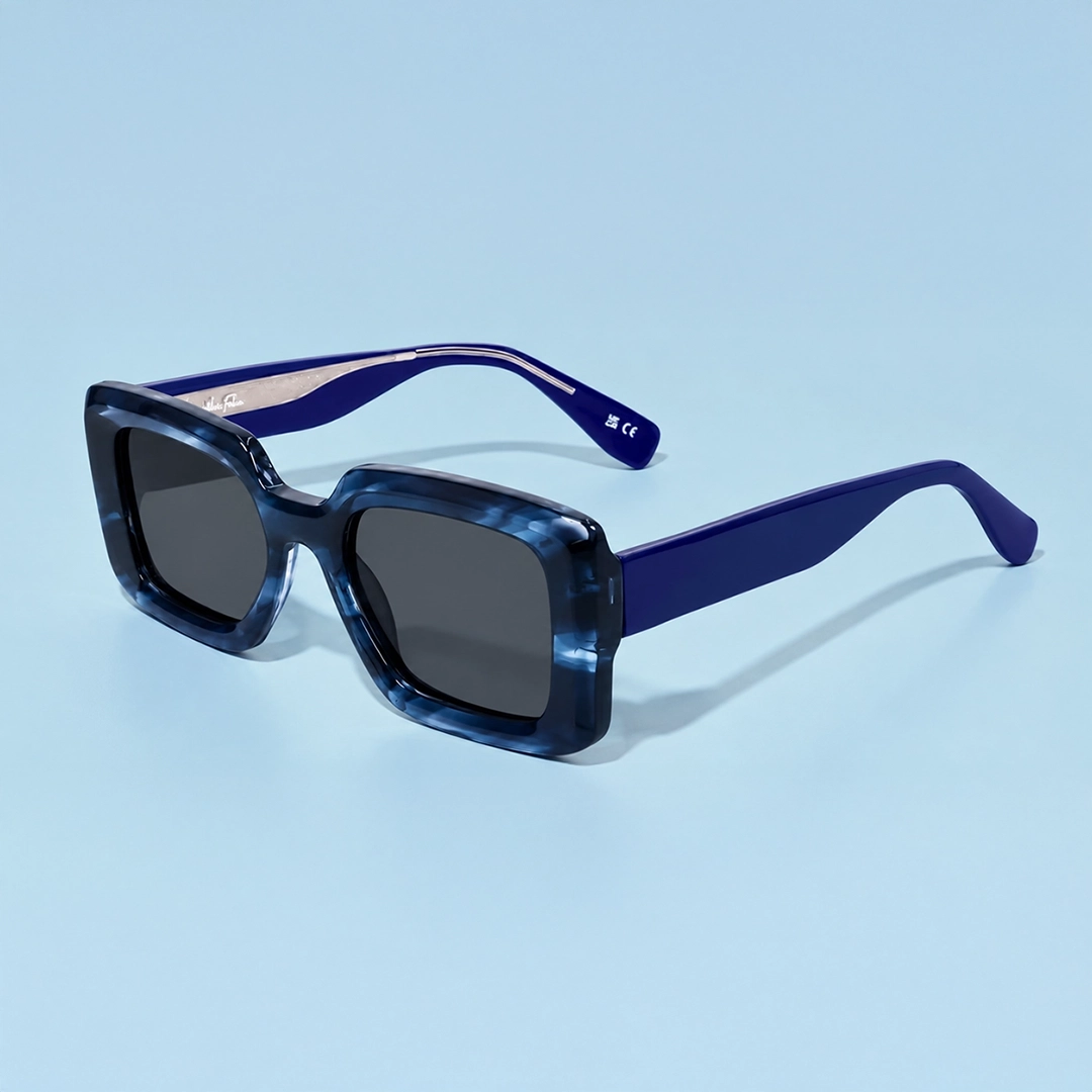 A close-up of premium black-framed pilots with polarised lenses, displayed on a geometric white block against a soft, bright background.