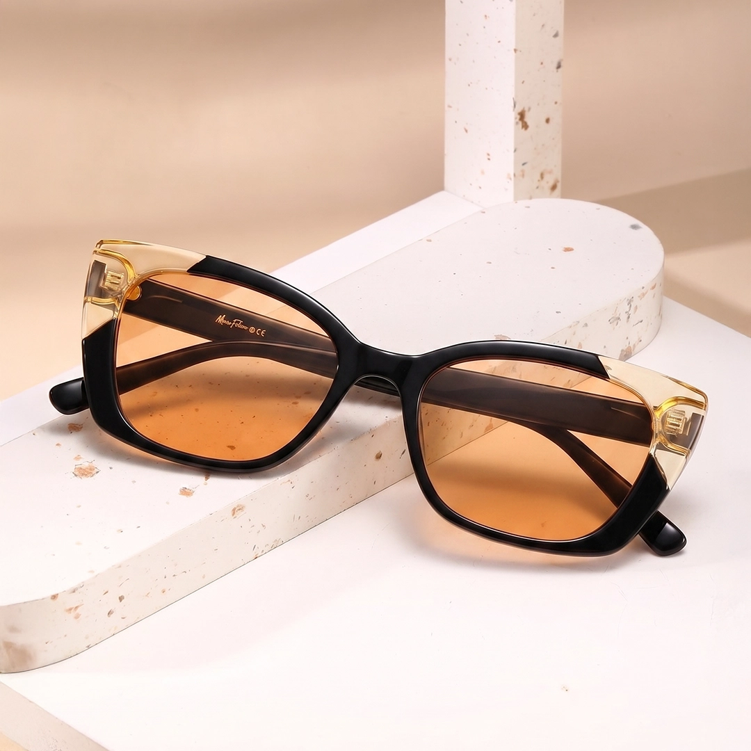 Oversized butterfly sunglasses with black frames and purple marbled accents on a white pedestal, set against a soft purple gradient banner background.