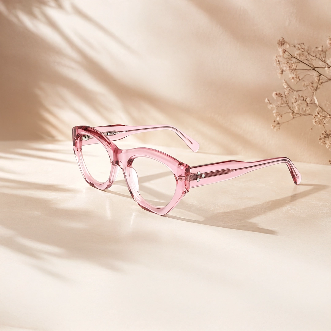 Pink Glasses Translucent crystal pink round glasses frames resting on a reflective soft pink background, showcasing a trendy and chic monochrome aesthetic.