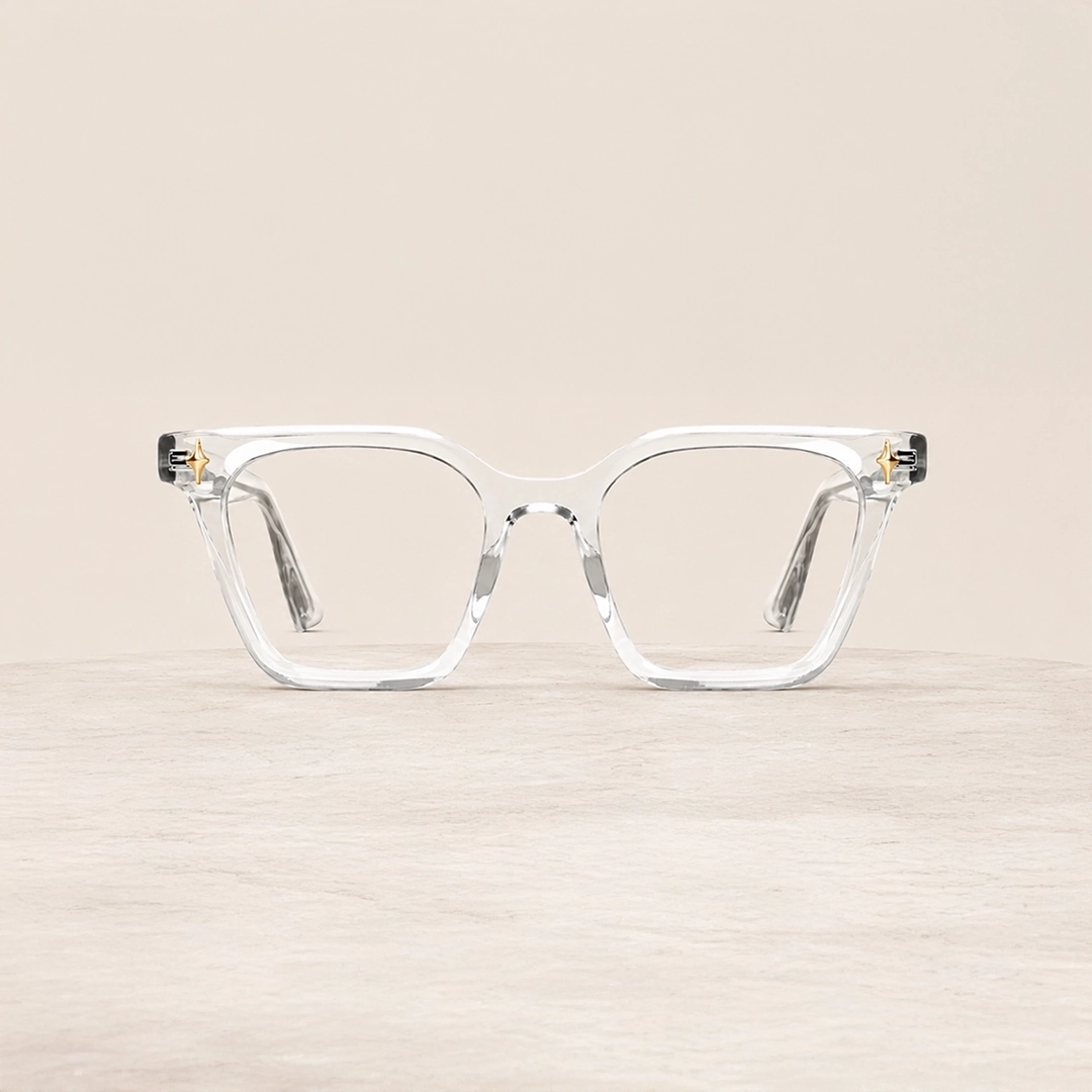 Clear Glasses The image features a close-up of clear acetate eyeglasses in a chunky rectangular frame that is placed on a white stand against a light grey background. The image has content that says Clear Glasses. It also has a discount offer by Specscart and Trustpilot reviews.