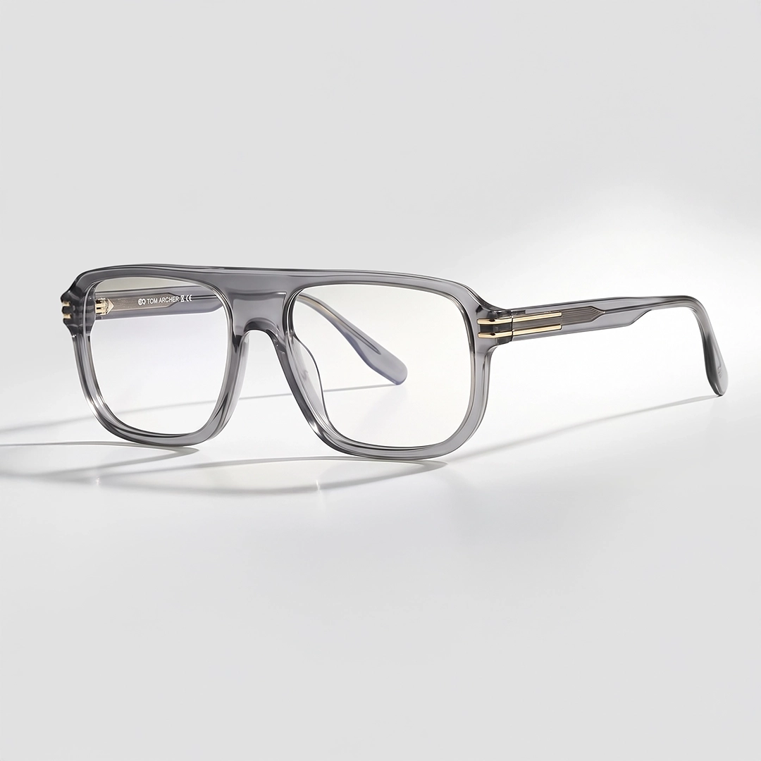 Stylish, angular square-framed glasses with glossy translucent grey frames, resting on a bright white background.