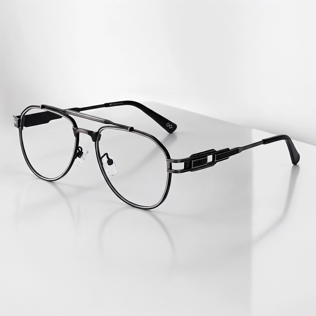 Gunmetal Glasses Classic round glasses with thin, minimalist gunmetal-colored metal frames resting on a light, curved surface.