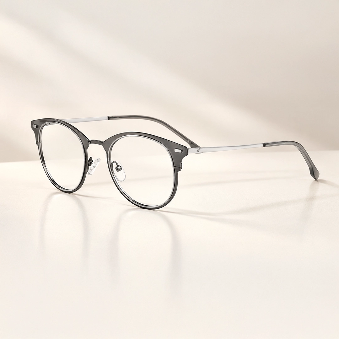 Lightweight silver titanium glasses with thin geometric frames resting on a clean white background, showcasing a durable and minimalist design.