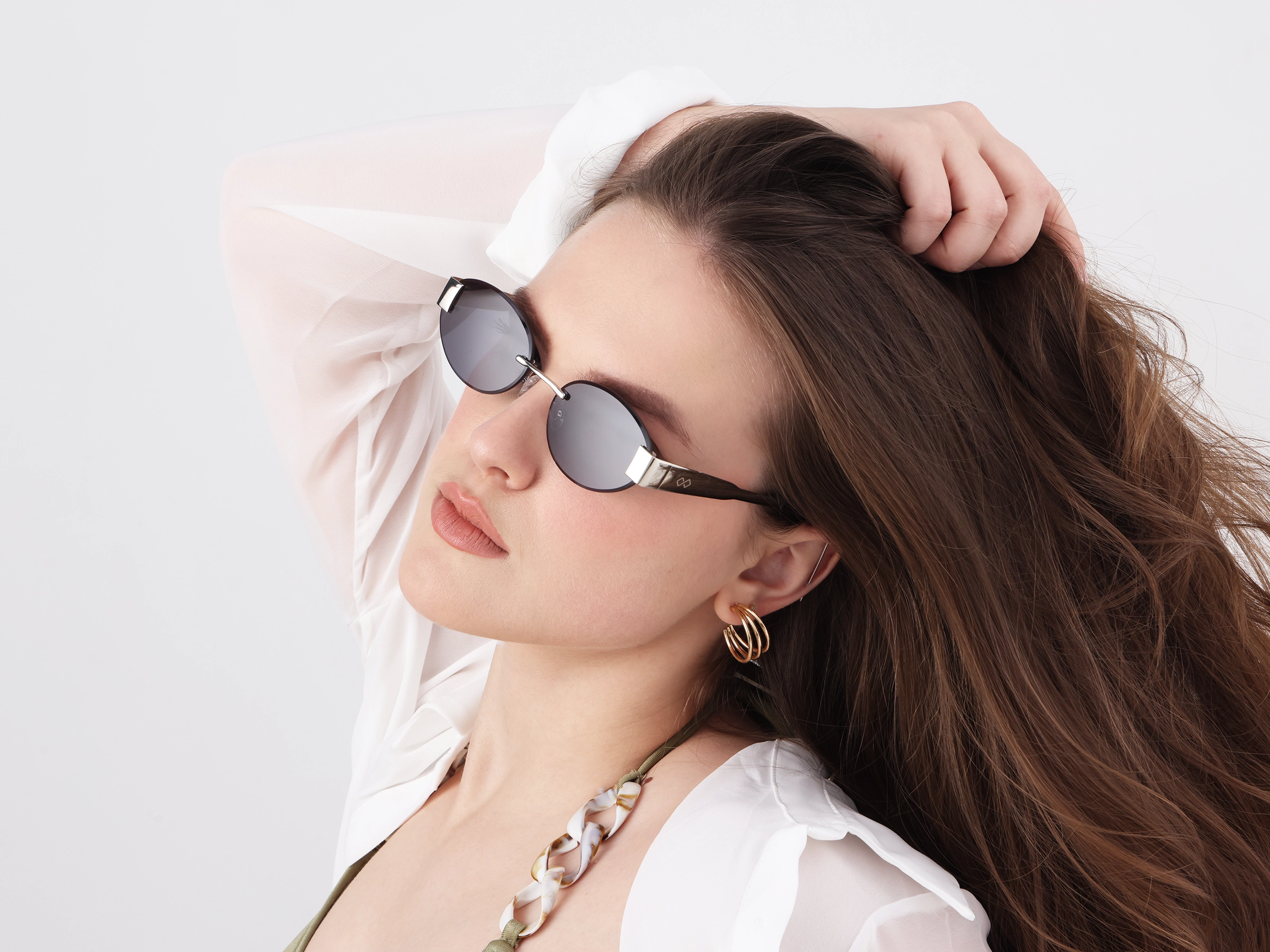 Oval Silver Rimless Sunglasses With Blue Tint