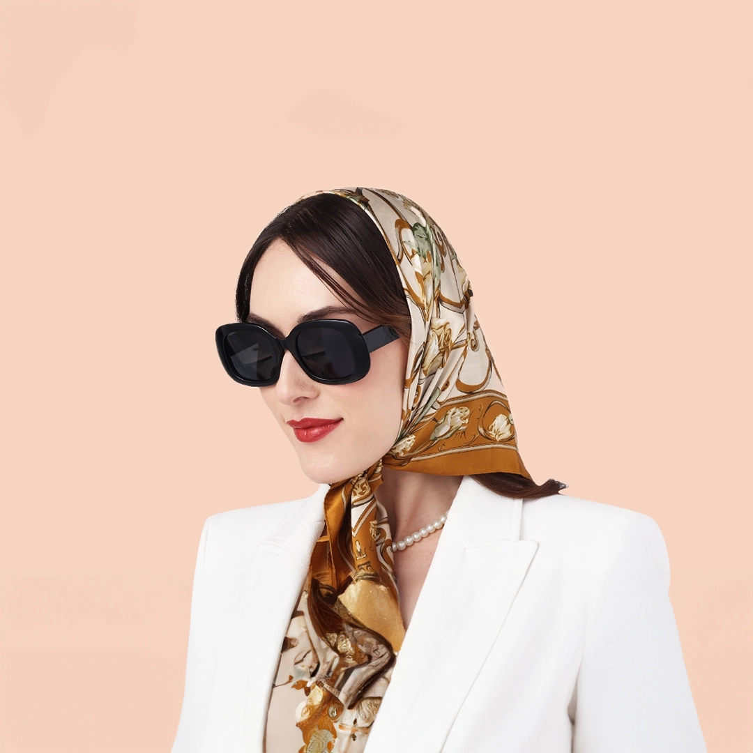 Specscart black sunglasses banner featuring a stylish woman wearing oversized black frames with a silk headscarf and white blazer.
