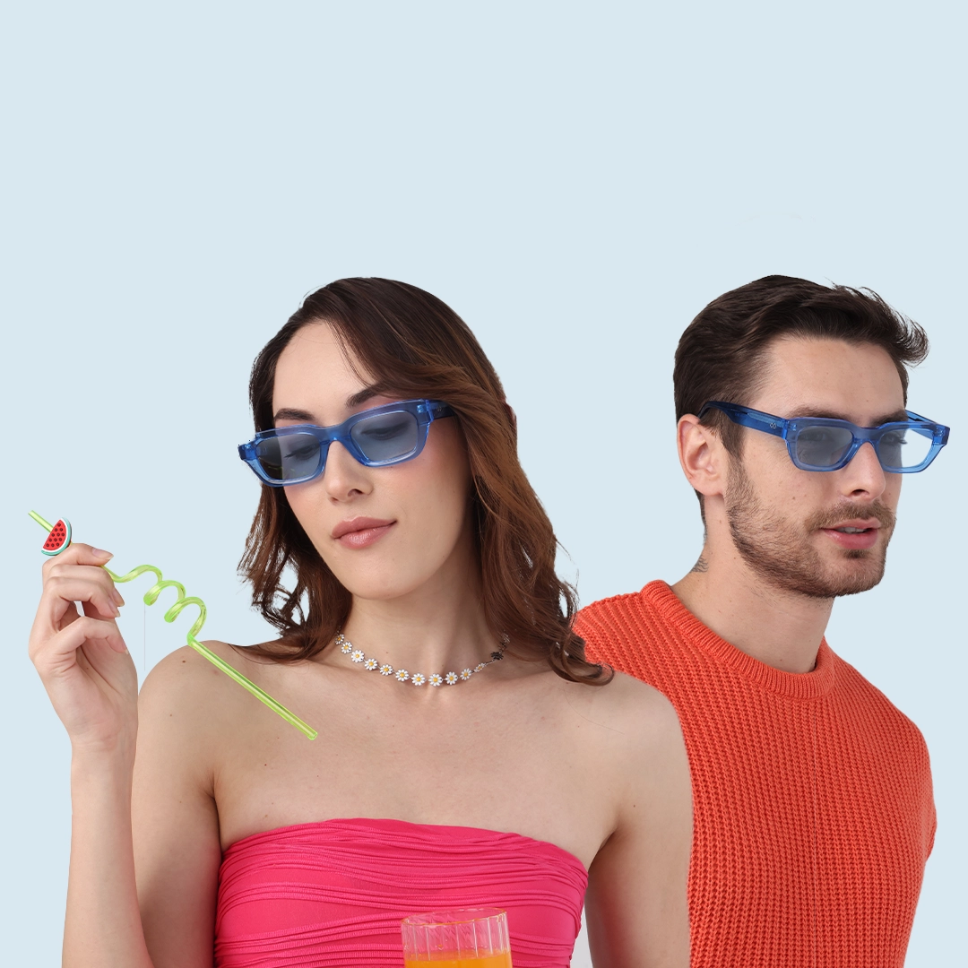 Blue Sunglasses A man and woman wearing stylish blue-tinted sunglasses against a light blue background. The woman holds a green curly straw with a charm.