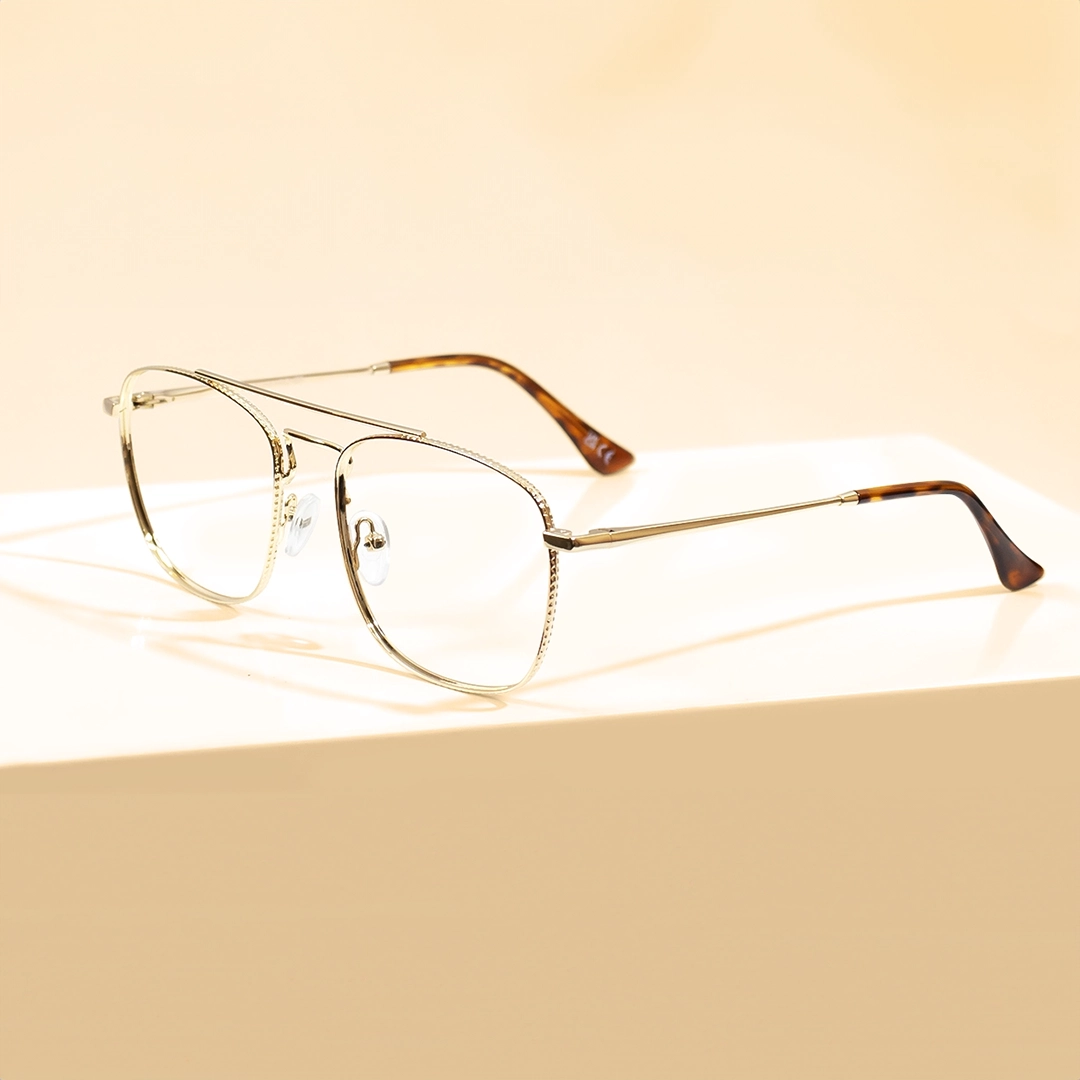 Gold Glasses The banner features stylish glasses with gold-coloured metal rectangular frames, featuring intricate edges and tortoiseshell-patterned temple tips, presented on a white pedestal against a light beige background. The left side of the banner showcases promotional text for Gold Glasses and an Excellent Trustpilot rating.