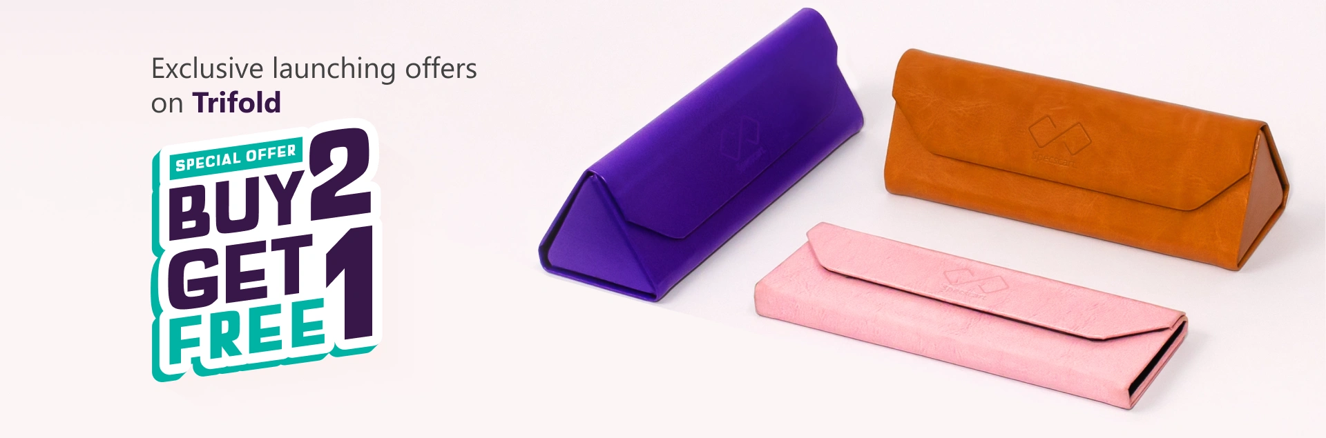 Banner advertising ‘Exclusive Launching Offer On Trifold, Buy 2 Get 1 Free’ featuring three pastel-coloured Specscart trifold cases in pink, purple, and brown, arranged in pairs on a pale background.