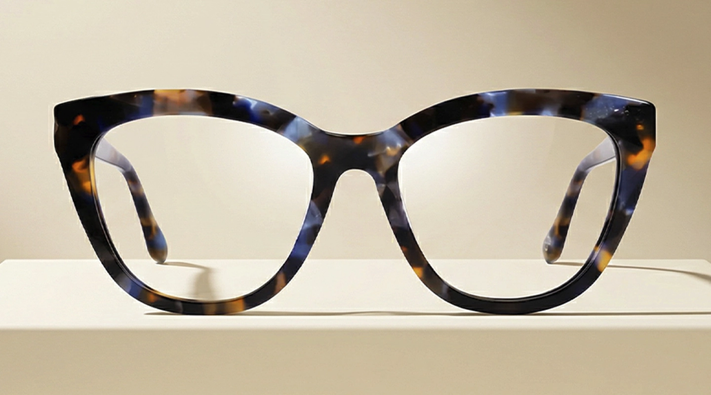 Cat Eye Glasses Stylish cat-eye glasses featuring a unique gradient frame that fades from maroon corners to a clear pink base, set on a soft pink background.