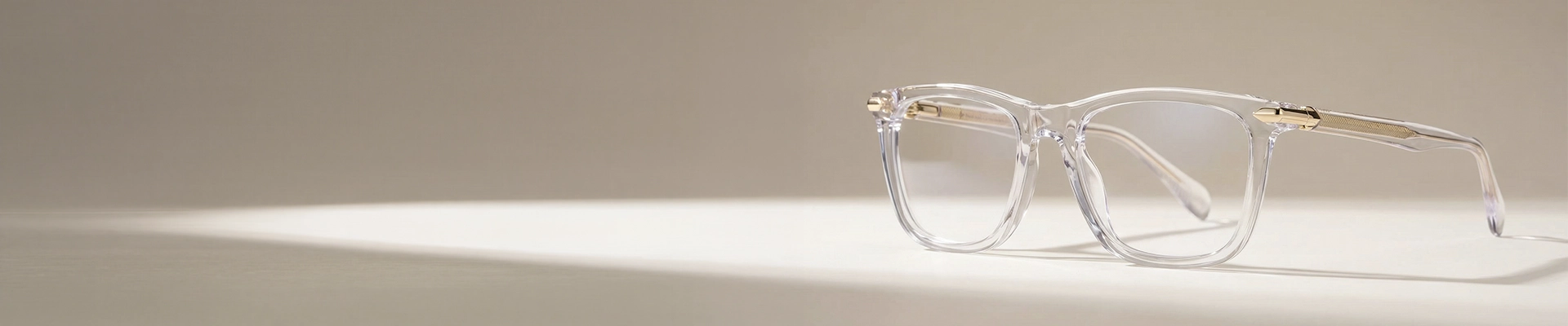 Clear Glasses The image features a close-up of clear acetate eyeglasses in a chunky rectangular frame that is placed on a white stand against a light grey background. The image has content that says Clear Glasses. It also has a discount offer by Specscart and Trustpilot reviews.