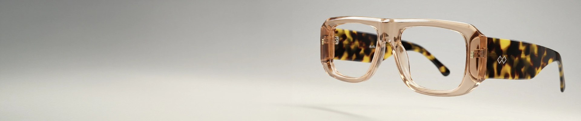 Oversized Glasses Amber oversized Specscart glasses with bold geometric frames, displayed closed on a cream textured fabric background.