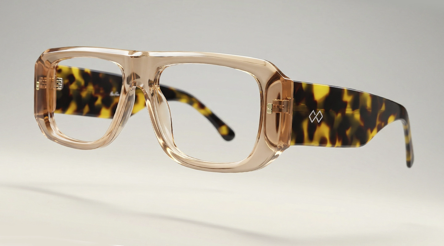 Amber oversized Specscart glasses with bold geometric frames, displayed closed on a cream textured fabric background.