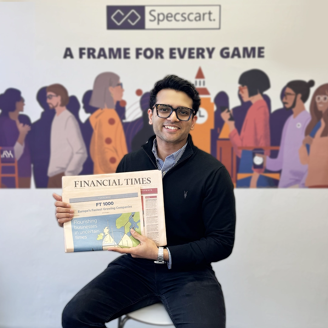 Specscart founder Sid Sethi receiving ‘the Emerging Entrepreneur Award’ from The Business Desk. The background features event signage and branding for the award presentation.