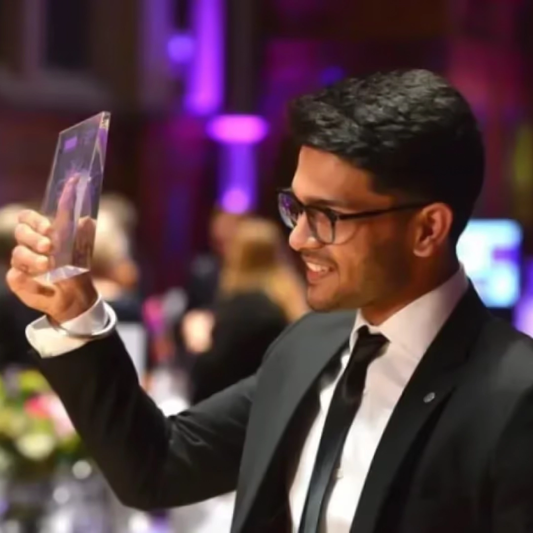 Specscart founder Sid Sethi receiving ‘the Emerging Entrepreneur Award’ from The Business Desk. The background features event signage and branding for the award presentation.