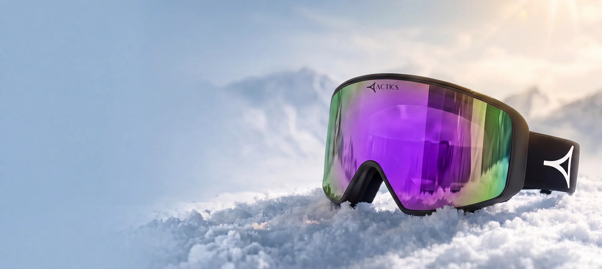 Ski goggles with a curved, mirrored lens reflecting a dramatic snowy mountain landscape and a vibrant purple sky. The purple colour gradient on the lens stands out against the crisp white snow and rugged peaks in the background. Set on a black strap with the Specscart Actics logo in bold white, the goggles are angled prominently in the foreground, conveying a sense of premium style and advanced winter sports gear.