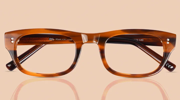 Glossy brown acetate glasses with a striped tortoiseshell pattern on a beige background, showcasing a classic rectangular frame style.